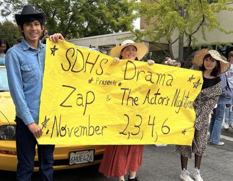 Drama students promoting their performance of Zap and The Actors Nightmare at the homecoming parade