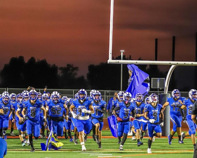 San Dimas running onto the field