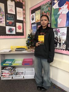 Londyn Graham holds her respective book, Dead Poets Society