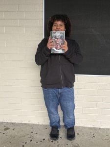Christopher Jollevet holds his respective book, Midnight Sun